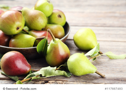 Ripe pears on grey wooden table