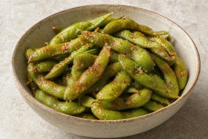 Schale mit gegarten Edamame-Schoten, gewürzt mit Meersalz, Paprikapulver und Chiliflocken