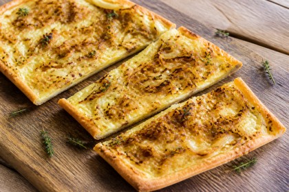 Herzhafter Zwiebelkuchen mit goldbraunen Sommerzwiebeln und Thymian